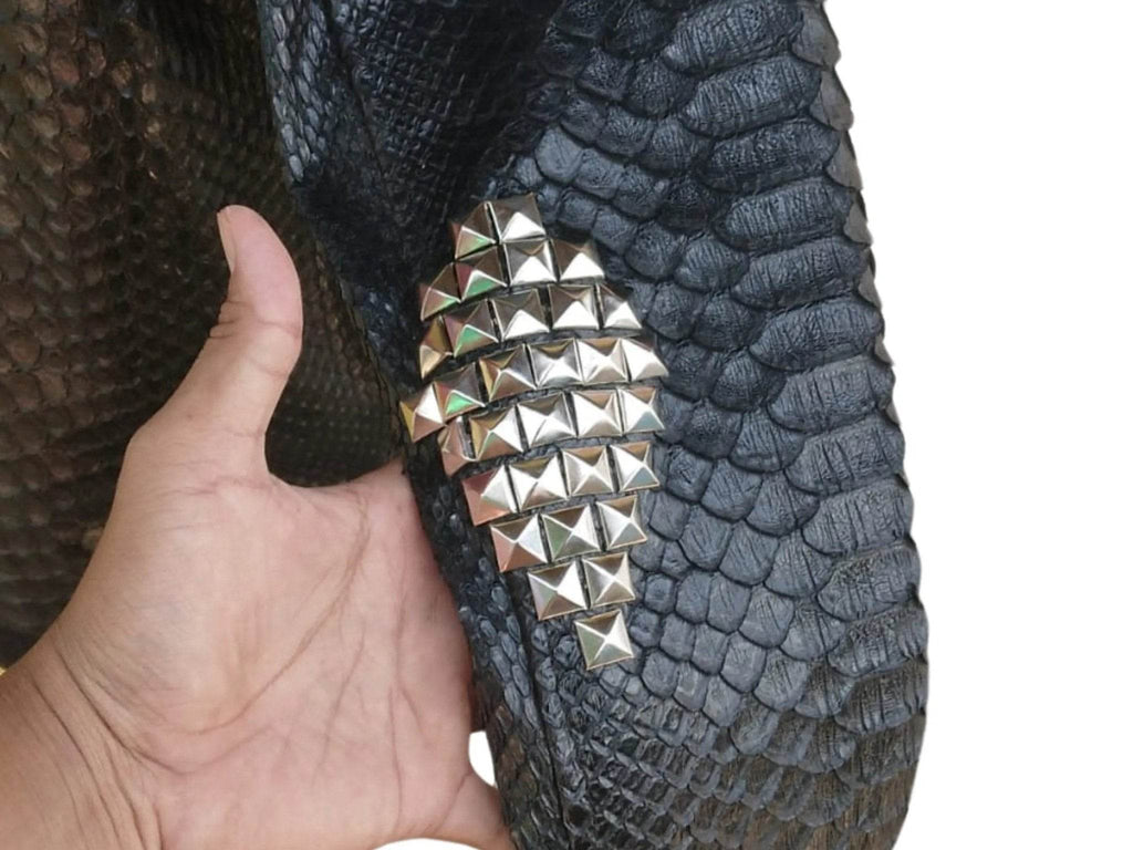 Snakeskin leather jacket shoulder with silver pyramid stud patch and textured scales